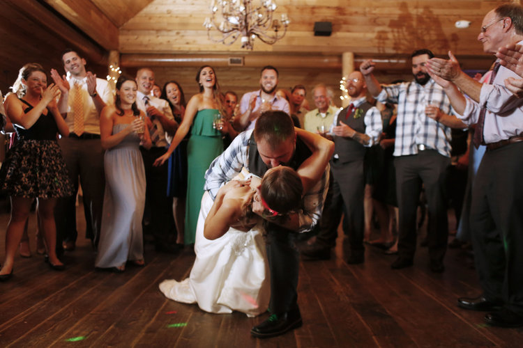 Newly weds on dance floor kissing in a deep dip