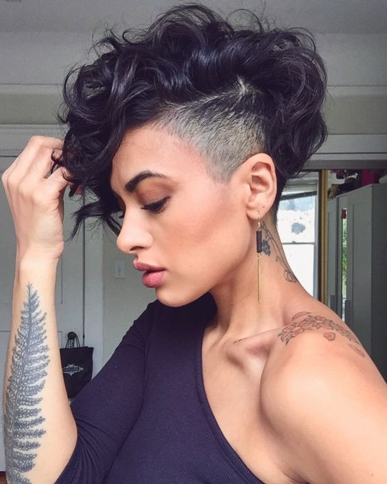 woman with dark hair and fade on side and short loose waves on top