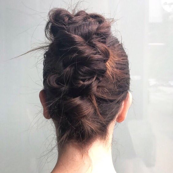 Messy twisted and braided french twist, with the front tightly pulled back, from behind