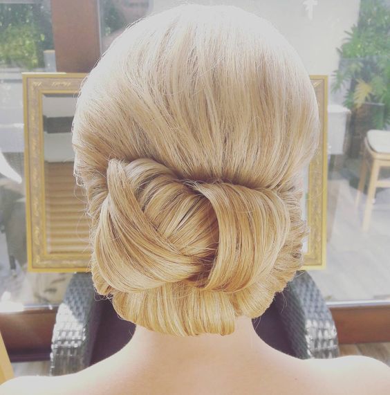 blond hair, sleeked back into a woven chignon