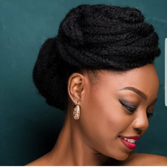woman smiling with natural hair coiled on top and back of head