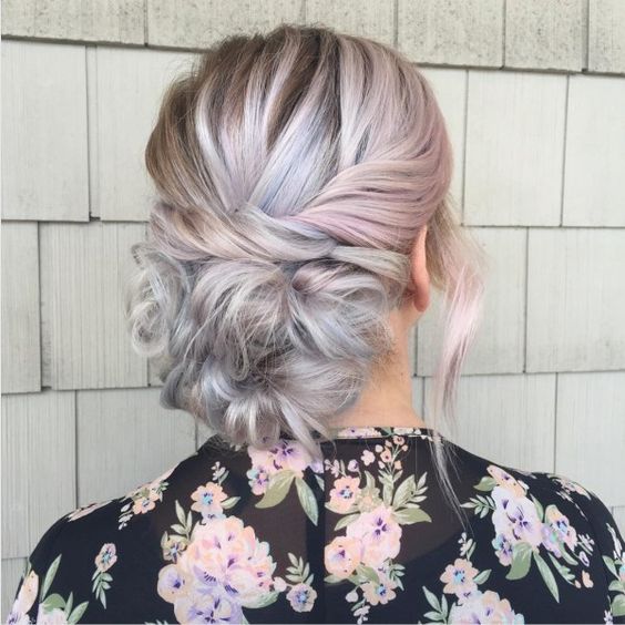woman with pink and grey hair gathered into horizontal twist across the back of her head 